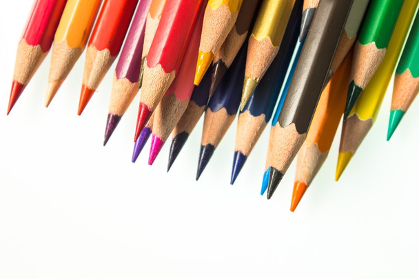 close-up of a colorful pencils in a plastic glass on white background. - Photo, image