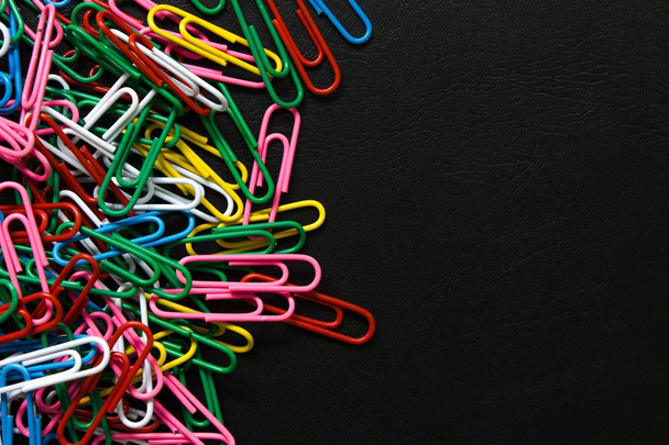 colorful paper clips on black background - Zdjęcie, obraz