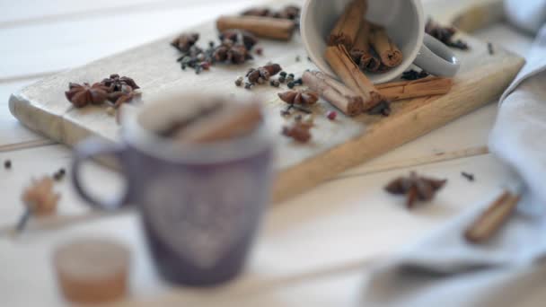 Cups with anise, cinnamon, cloves and pepper on a wooden old table. - Video