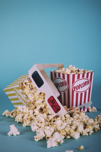 Popcorn bucket against a blue background Vintage Retro Filter. - Фото, зображення