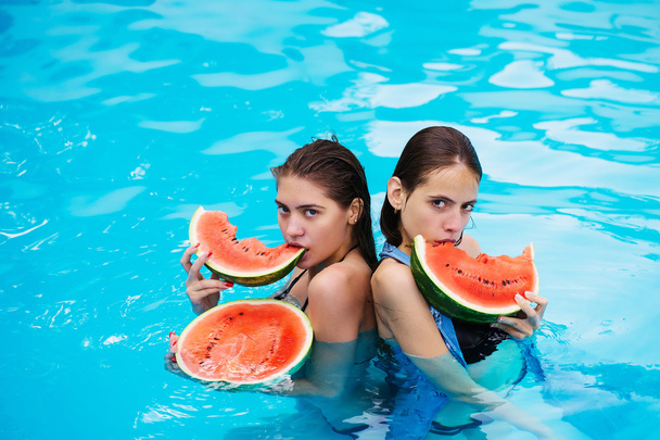 women with watermelon in swimming pool - Photo, image