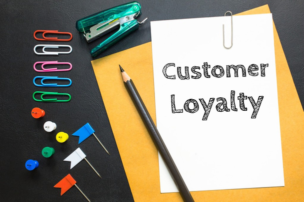 Text Customer loyalty on white paper background / business concept - Foto, imagen