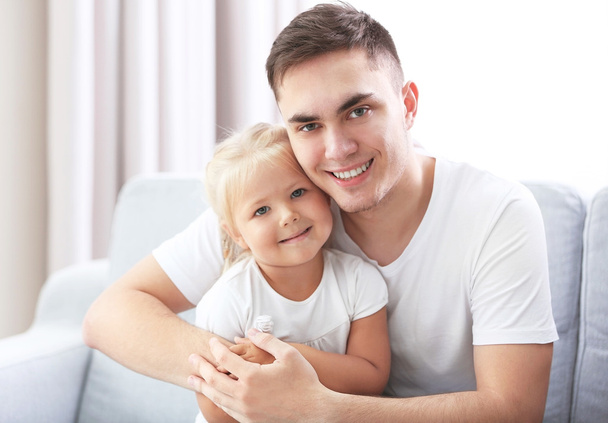 Happy father with daughter on couch at home  - Zdjęcie, obraz