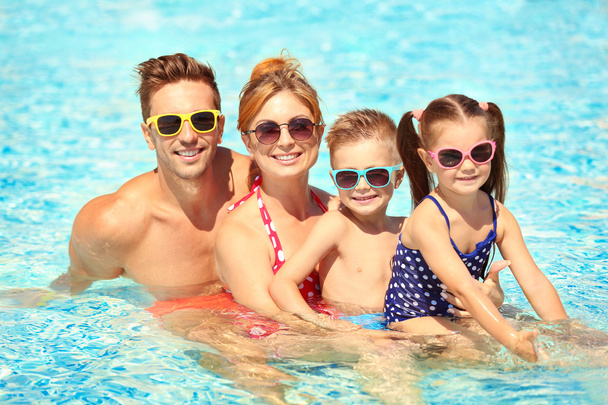 Family in swimming pool - Фото, изображение