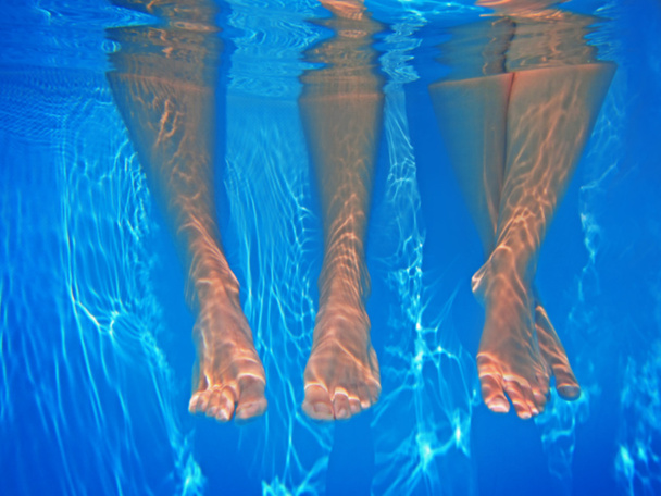 Legs underwater in pool - Фото, изображение