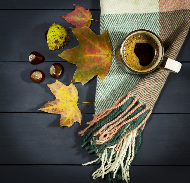 Tasse Kaffee mit Herbstblättern und Kastanien. - Foto, Bild