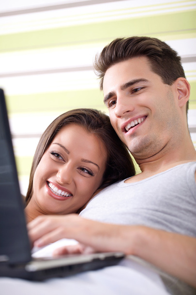 Young couple relax in bed with laptop - Foto, Imagen