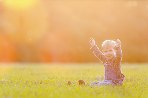 Happy child outdoor, yellow field raised his hands. Autumn, fall - Foto, afbeelding