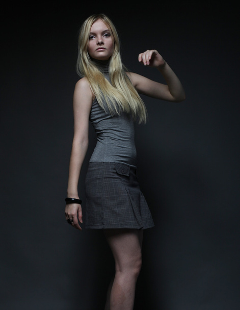 Portrait of beautiful young blonde girl in black dress. - Photo, image