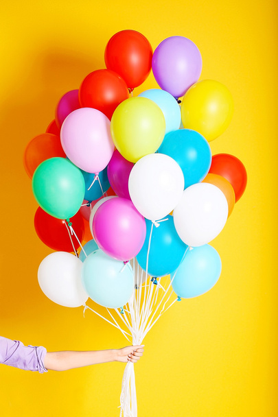 Woman holding many colorful balloons - Photo, Image