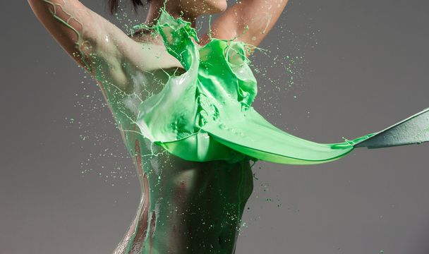 The beautiful woman with green liquid paint over her body - Valokuva, kuva