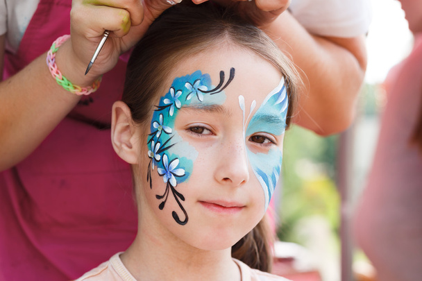 Female child face painting, making butterfly process - Zdjęcie, obraz