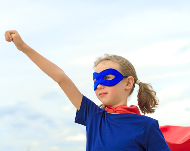 Superhero kid against blue sky background. - Foto, Imagen