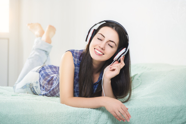 happy woman in headphones with closed eyes  - Valokuva, kuva