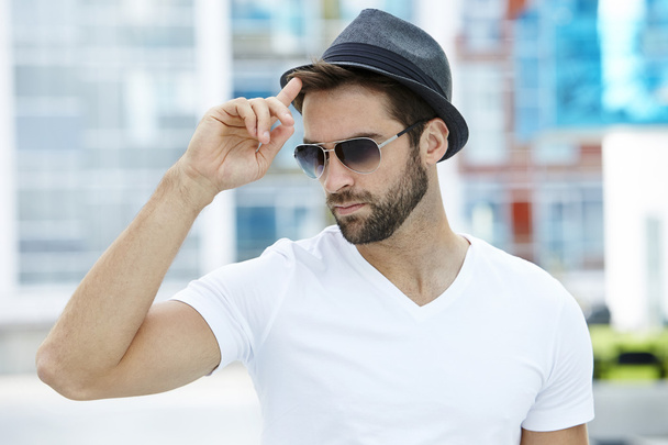 Cool guy tipping hat - Foto, afbeelding