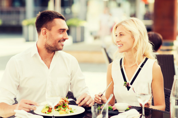 happy couple eating dinner at restaurant terrace - Fotó, kép