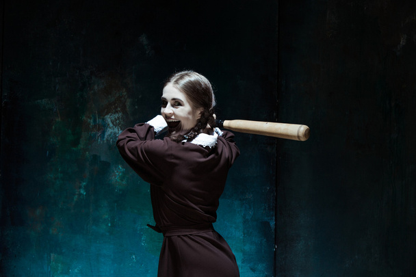 Portrait of a young girl in school uniform as killer woman - 写真・画像