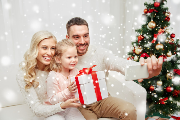 family taking selfie with smartphone at christmas - Valokuva, kuva