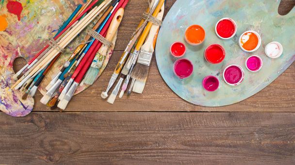 Colorful paints, brushes, palette on the wooden background.  - Fotoğraf, Görsel