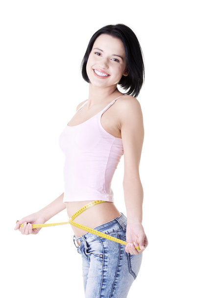 Young woman measuring her waist - Foto, Bild