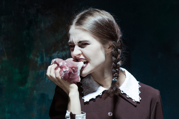 Bloody Halloween theme: crazy girl with raw meat - Фото, зображення