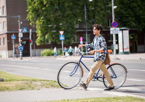 young man with fixed gear bicycle on crosswalk - Fotó, kép