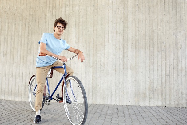 young hipster man riding fixed gear bike - 写真・画像