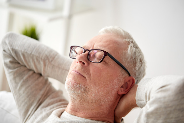 senior man in glasses relaxing on sofa - Zdjęcie, obraz