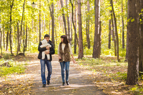 Young couple with newborn son outdoors in autumn - Photo, Image
