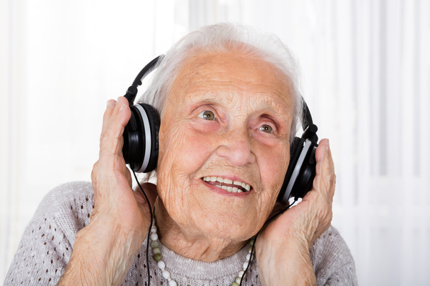 Senior Woman Using Headphones - Fotó, kép