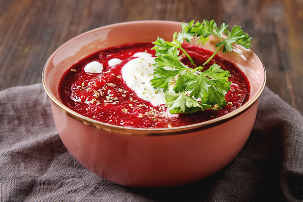 Traditional beetroot soup in a pink plate with Temyan, sour crea - Photo, image