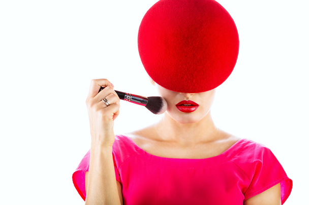 closeup  portrait of a girl in a red hat holding a brush in his  - Fotografie, Obrázek