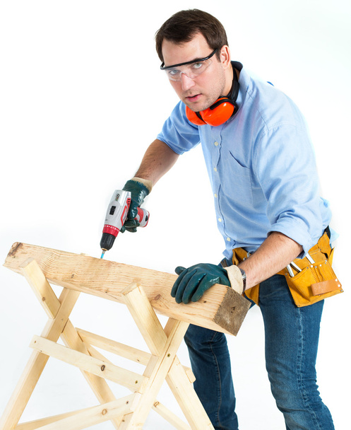 man with a drill on a white background - Фото, зображення
