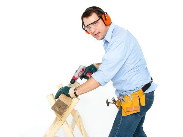 man with a drill on a white background - Foto, afbeelding