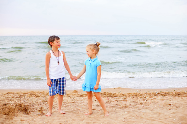 two children playing on beach - Фото, зображення