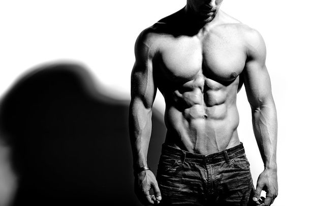 Portrait of strong healthy handsome Athletic Man Fitness Model posing near white wall - Φωτογραφία, εικόνα