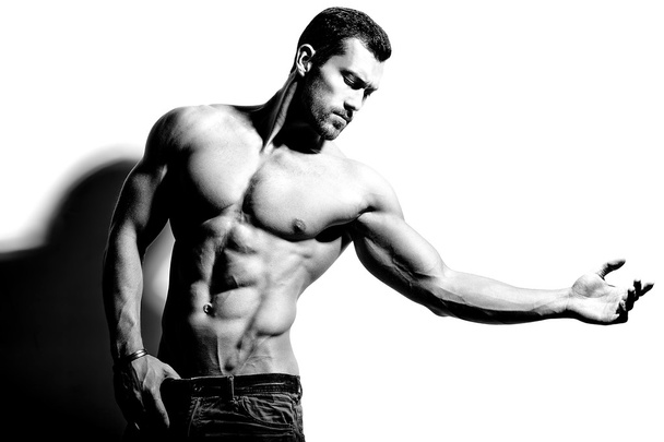 Portrait of strong healthy handsome Athletic Man Fitness Model posing near white wall - Photo, image