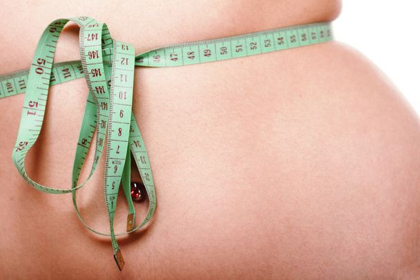 Woman slim stomach with measuring tape around it - Photo, Image