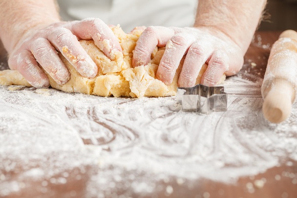 Pair of hands kneading dough - Fotó, kép