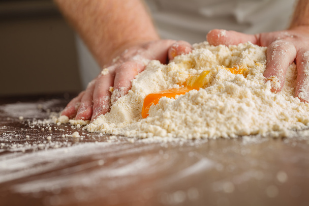 handful of flour with egg on a rustic kitchen. Against the backg - Fotoğraf, Görsel