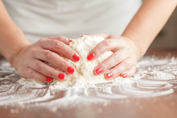 making raw dough by female hands on table - Φωτογραφία, εικόνα