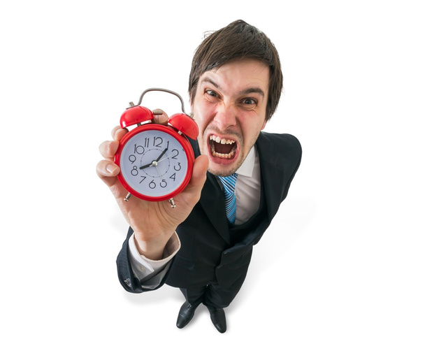 Deadline concept. Young crazy boss is yelling and holds clock in hand. Isolated on white concept. - Photo, Image