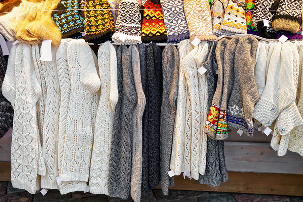 Calcetines de rodilla de lana colgados en el mercado navideño de Riga
 - Foto, imagen