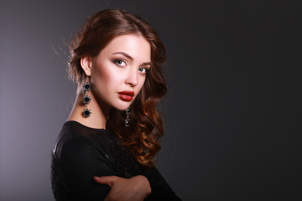 Beautiful woman with evening make-up in black dress - Фото, зображення