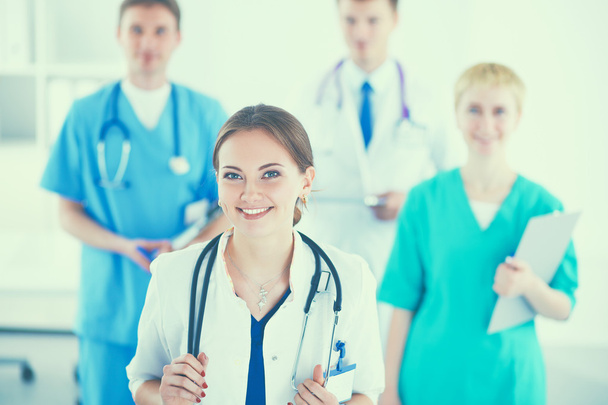 Attractive female doctor in front of medical group - Photo, Image