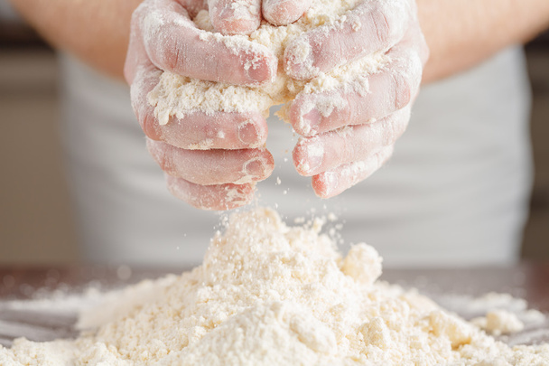 Hands kneading a dough - Фото, зображення
