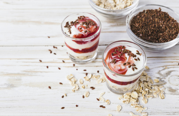 Homemade yogurt with berry jam, linseed and oat flakes - Фото, зображення