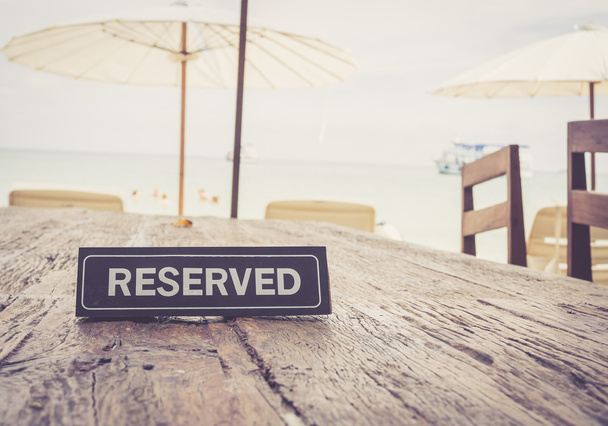 Banner reservado en la mesa del restaurante, fondo de playa; c vintage
 - Foto, Imagen