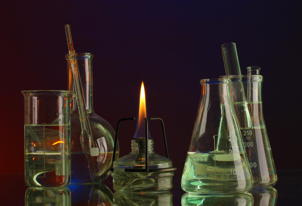 Spiritlamp and test-tubes on blue-red background - Фото, изображение