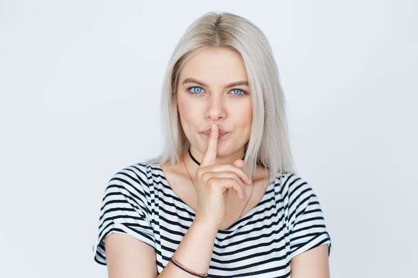 Portrait of beautiful blond woman with finger on lips - Photo, Image